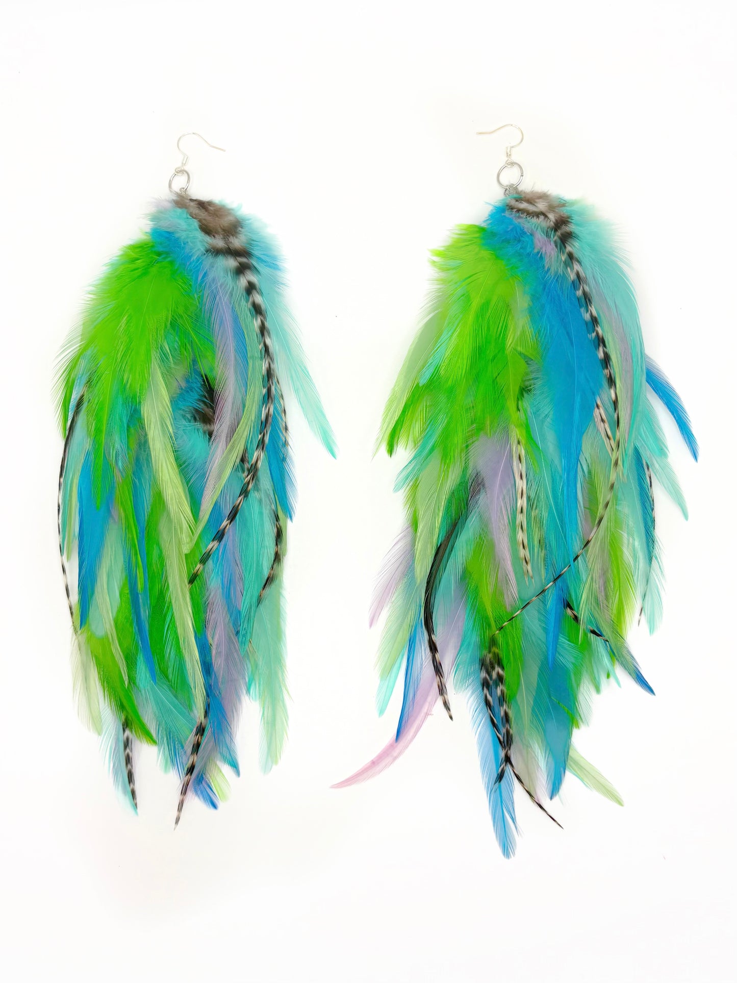 Feather earrings with green, blue, and white feathers on a white background