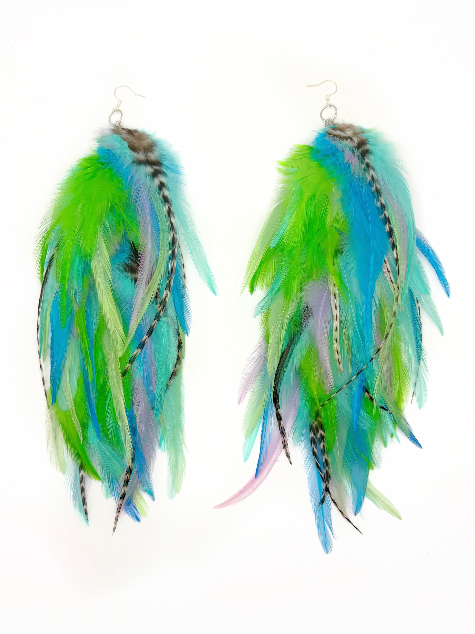 Feather earrings with green, blue, and white feathers on a white background