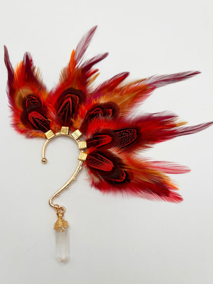 Rooster and pheasant ear cuff in vibrant red and orange colors. A wire wrapped quartz stone hangs from the bottom of the cuff.