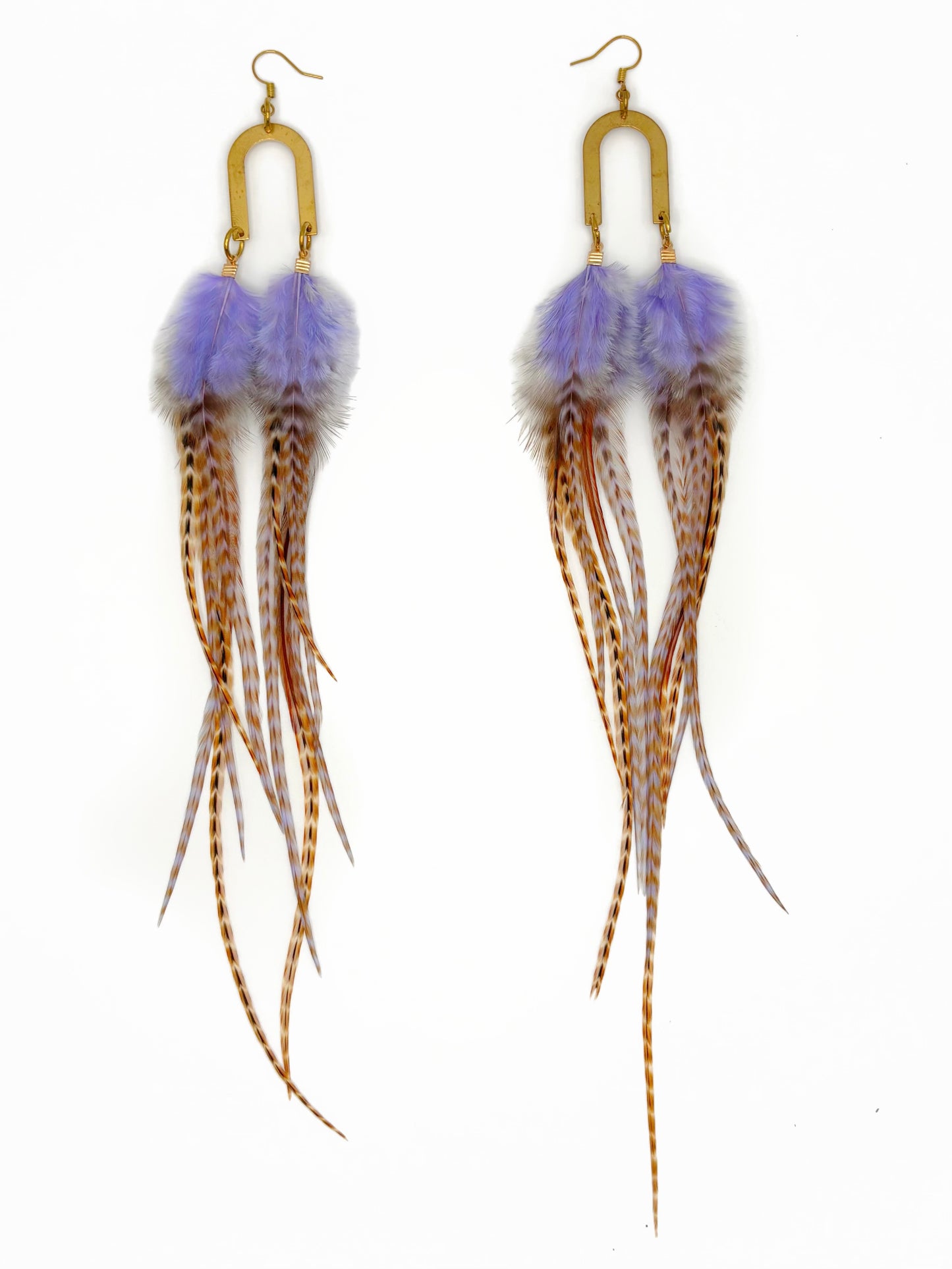 Feather earrings with purple pom-poms on a white background