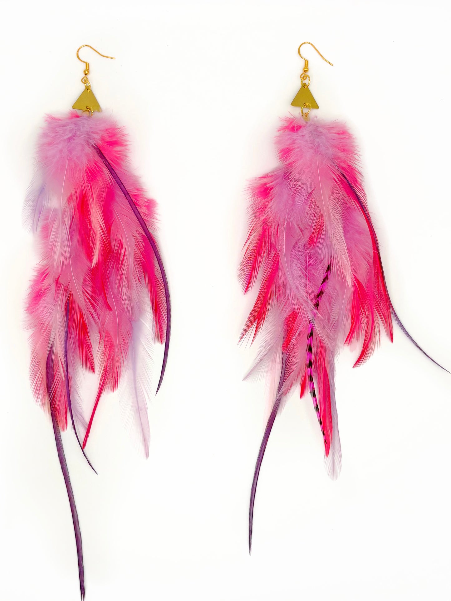 Pair of pink feather earrings on a white background