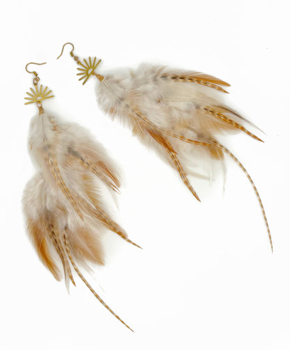 Feather earrings with gold accents on a white background
