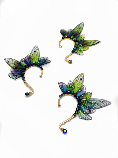 Green and purple fairy wing ear cuffs with blue rhinestone accents.