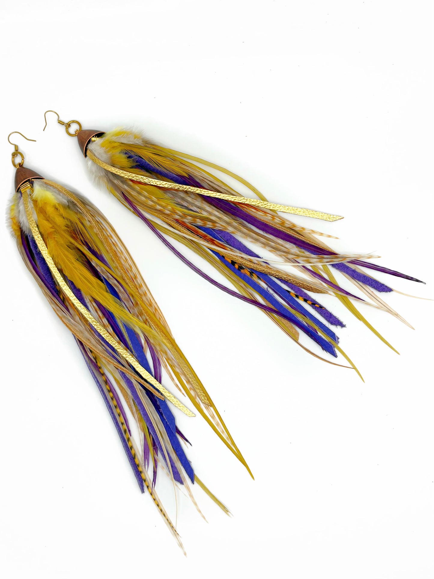 Pair of earrings with gold and purple feather-like designs on a white background