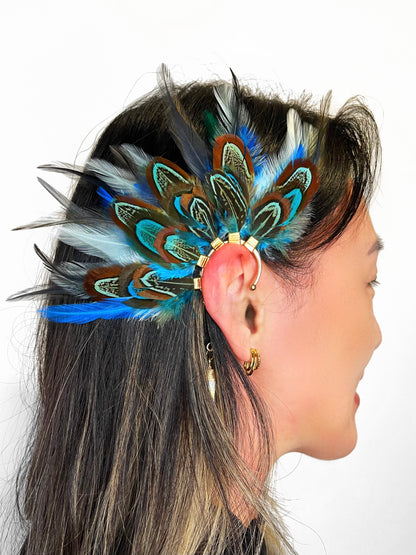 Turquoise blue, mint green and gray pheasant and rooster feather ear cuff, modeled on a woman. 