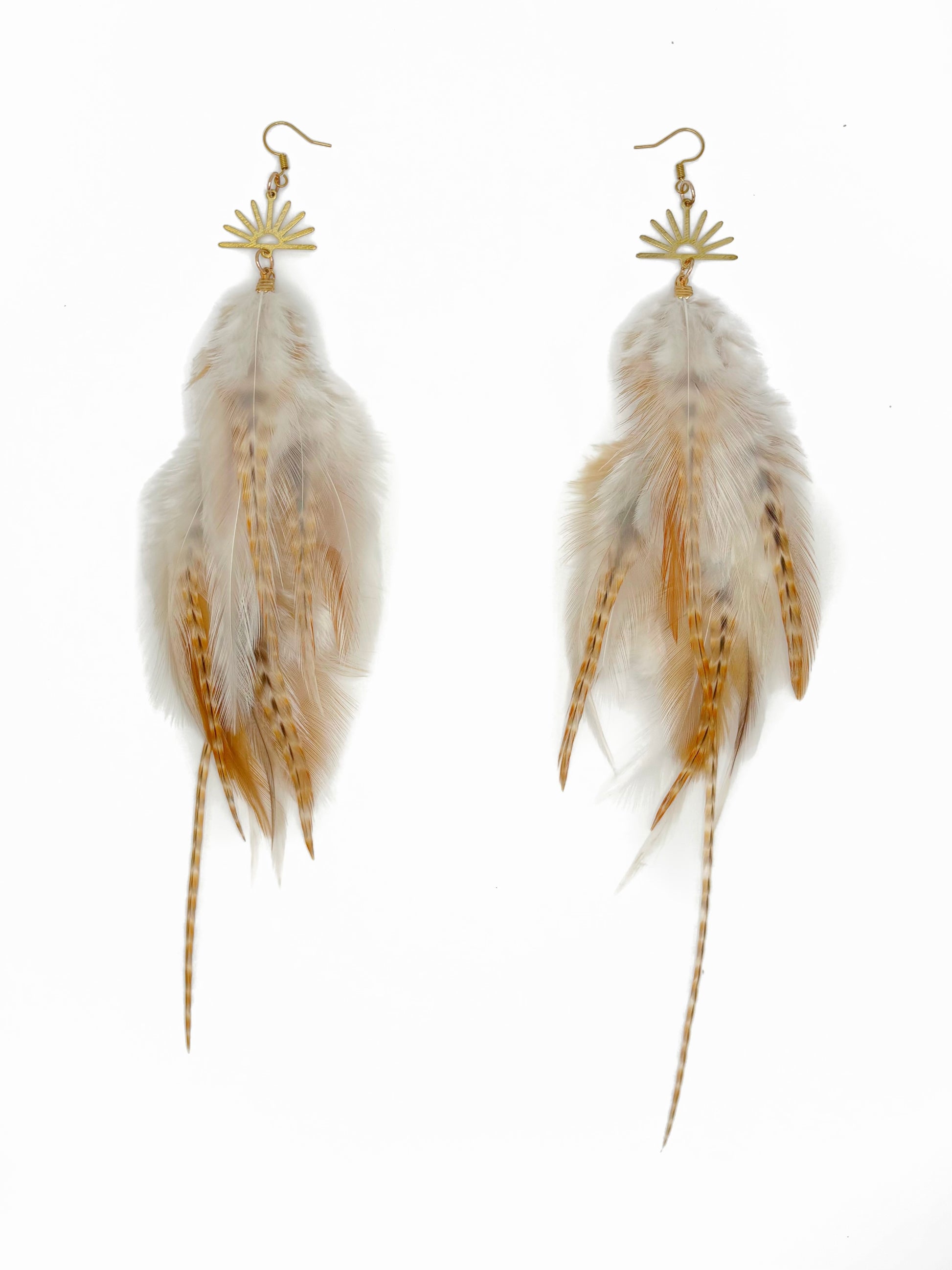 Feather earrings with gold accents on a white background