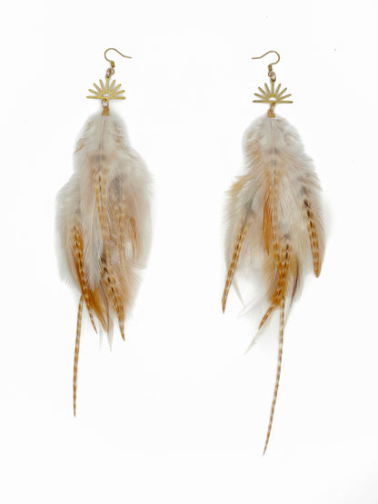 Feather earrings with gold accents on a white background