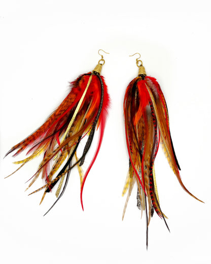 Long orange and red feather earrings with metallic gold and brown leather.