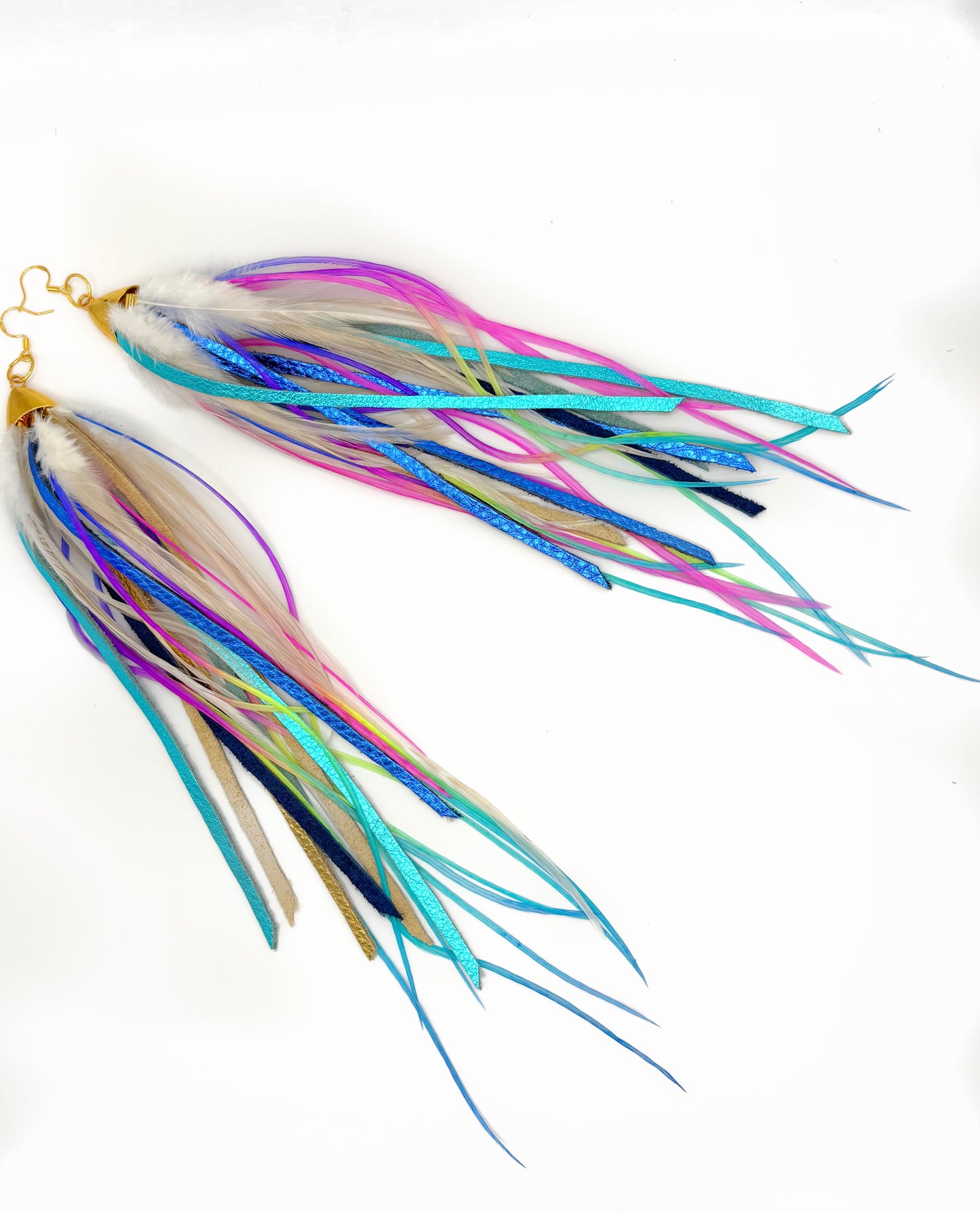 Colorful fishing lures with multiple tails on a white background