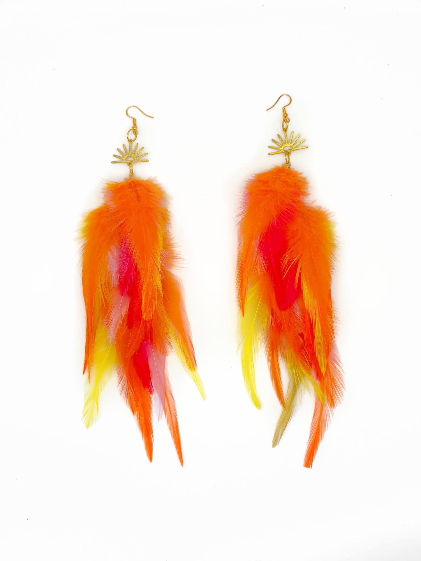 Feather earrings with orange, yellow, and pink feathers on a white background