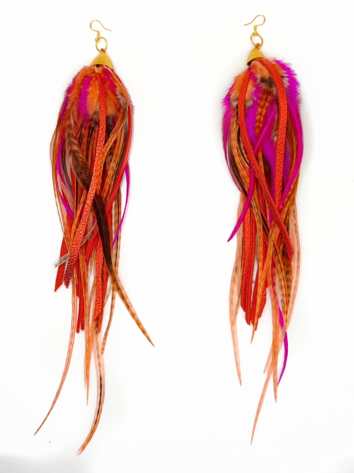Colorful feather earrings on a white background