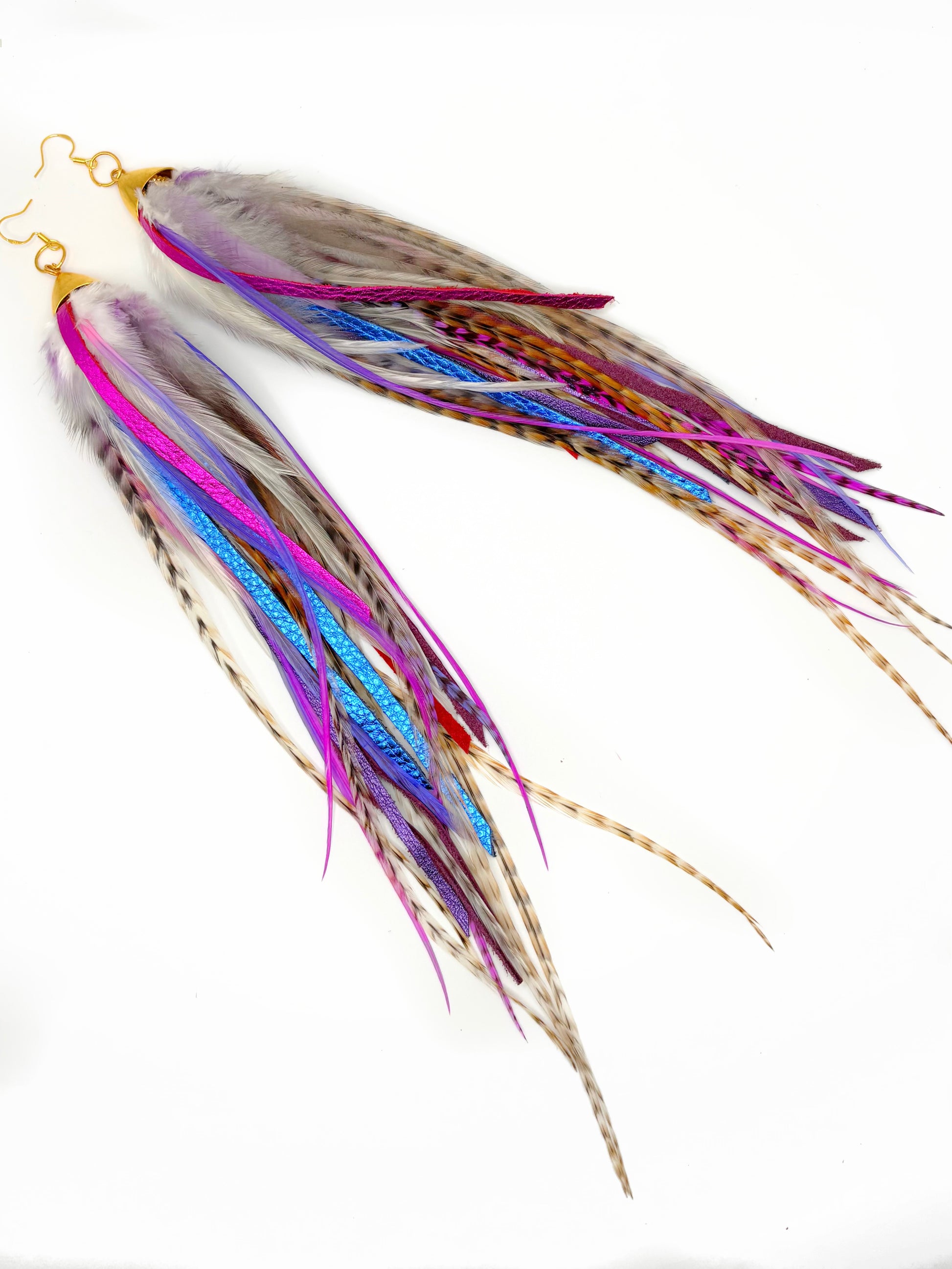 Colorful feather earrings on a white background
