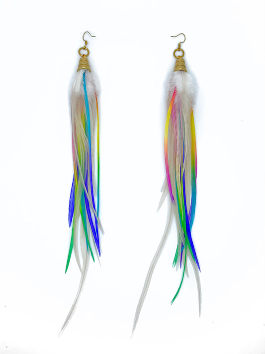 Long white feather earrings with neon rainbow accents. All feathers hang beneath a gold colored bead cap. 