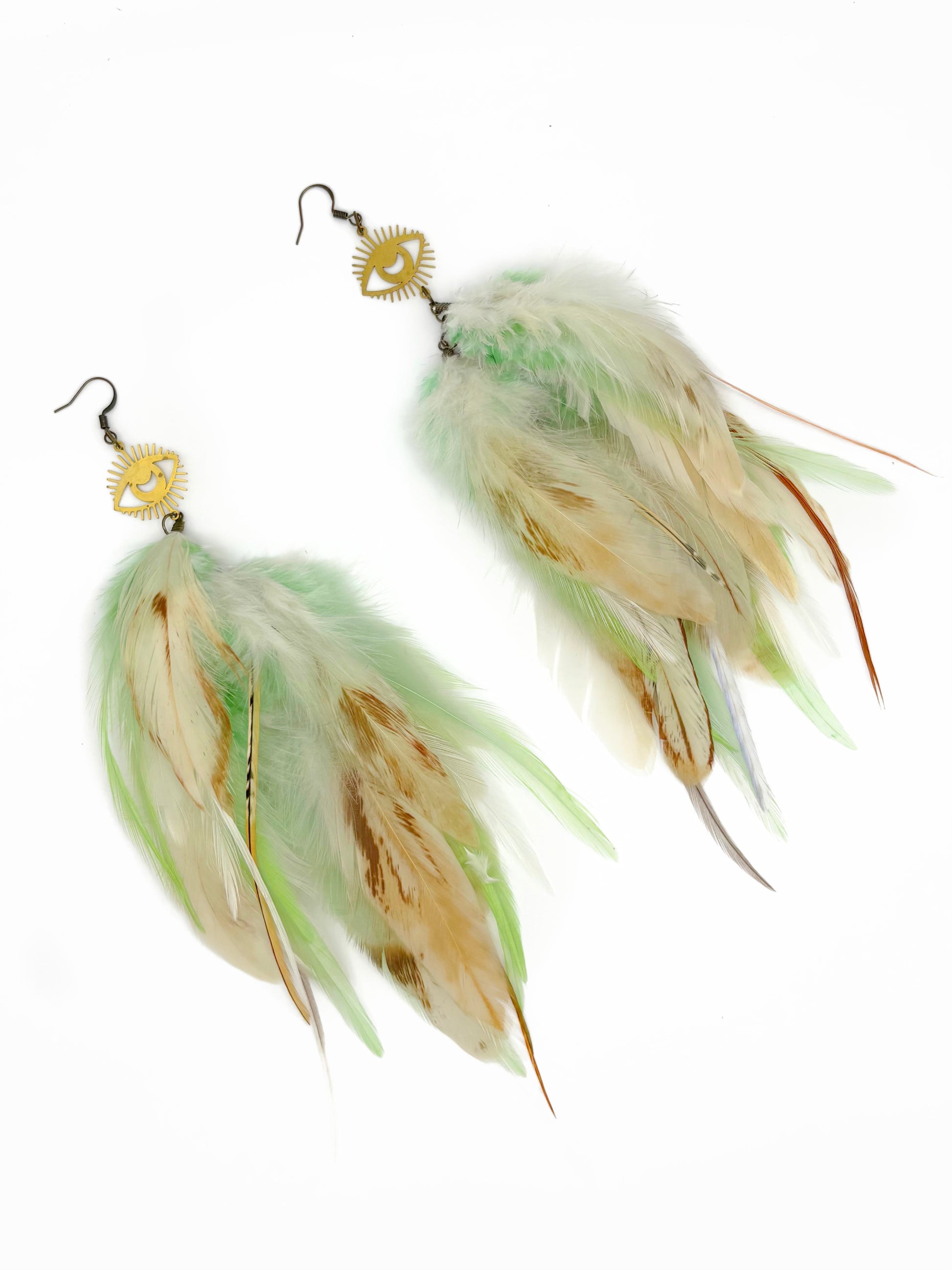Long cream and green feather earrings with gold eye pendants. 