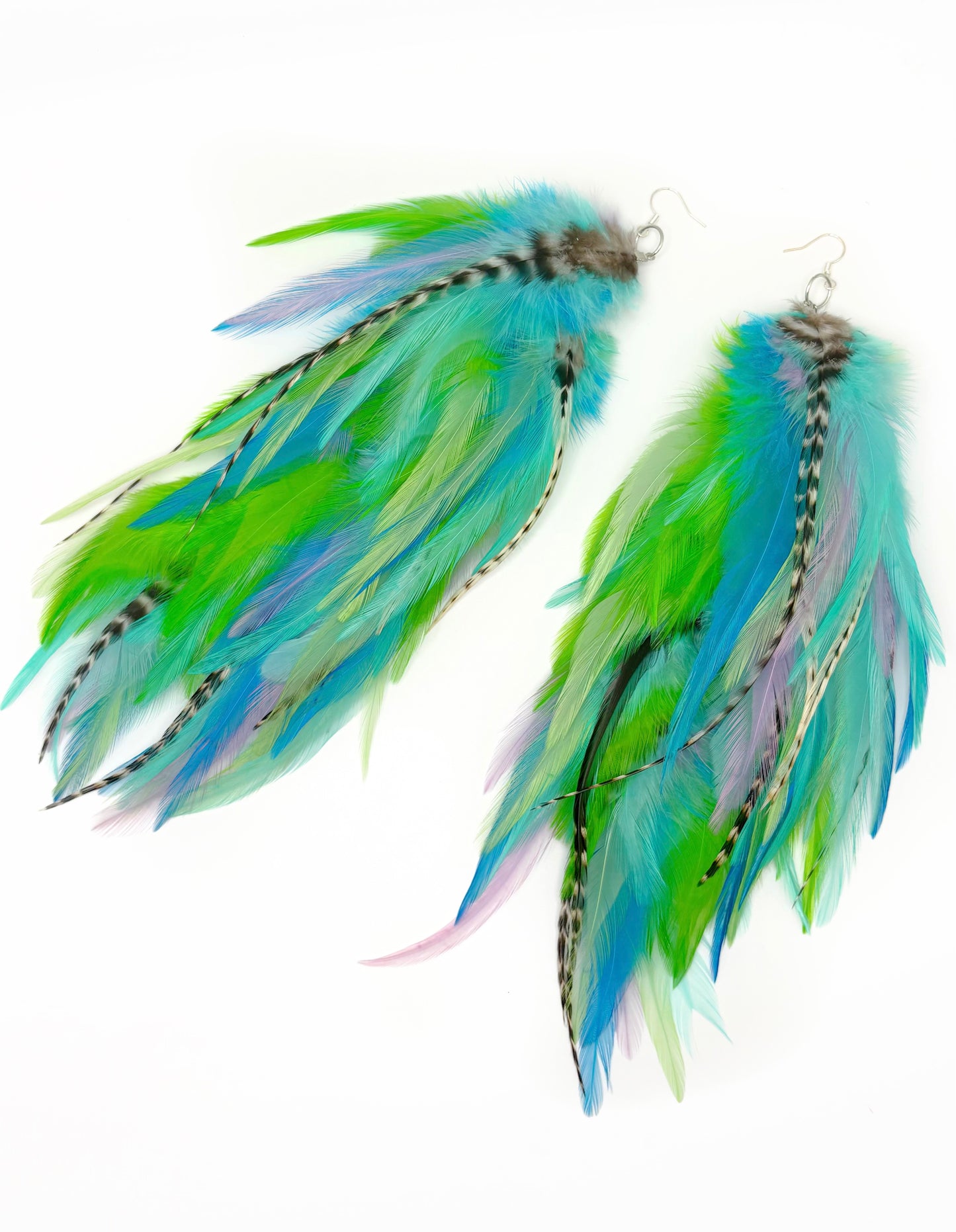 Pair of feather earrings with green and blue feathers on a white background