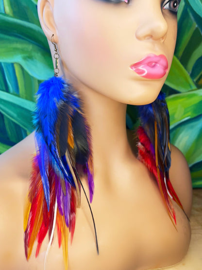 Vibrant long feather earrings displayed on a mannequin, showcasing bold colors of blue, purple, and red against a tropical background, ideal for statement-making bohemian style.