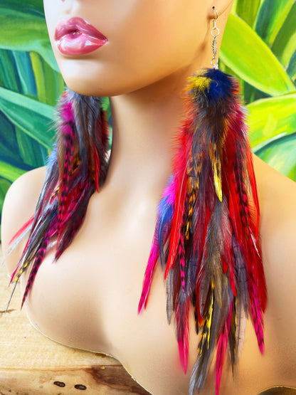 A mannequin head wearing long bohemian feather earrings, in cascading shades of gray, yellow, red, pink and blue. 