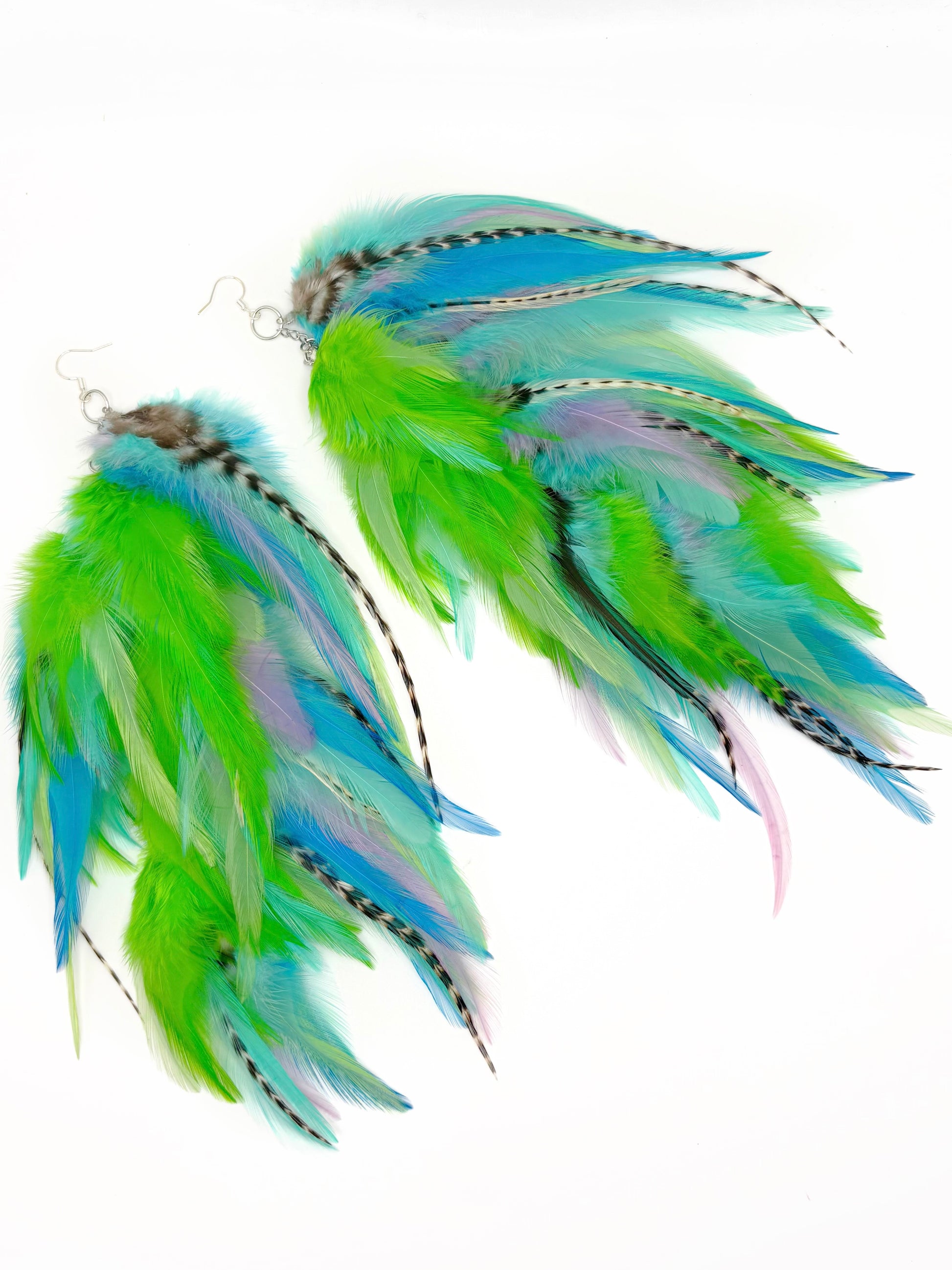 Pair of feather earrings with green and blue feathers on a white background