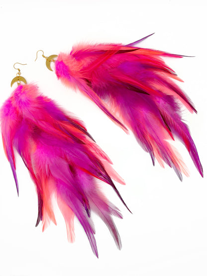 Long neon pink feather earrings.