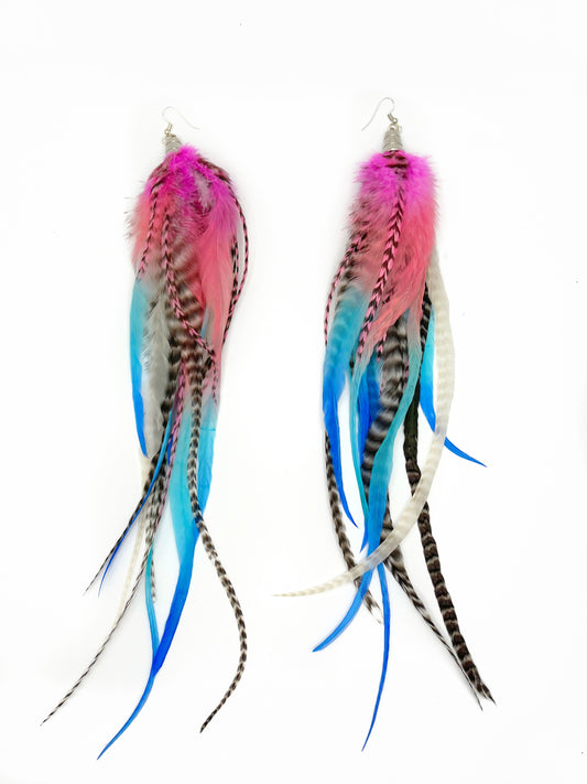 Long feather earrings in bright pink and blue tones. All Feathers hang from beneath a silver cap pendant. 