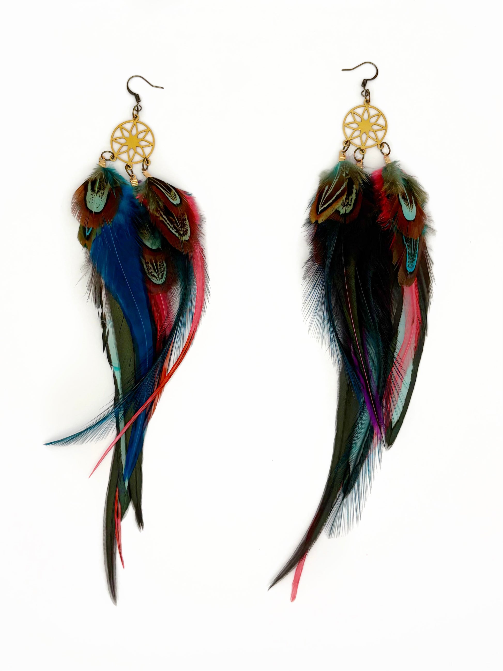 Colorful feather earrings with gold accents on a white background