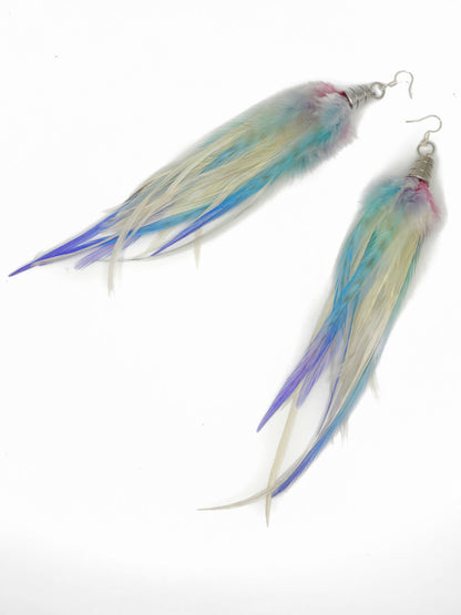 Pair of earrings with blue and white feathers on a white background
