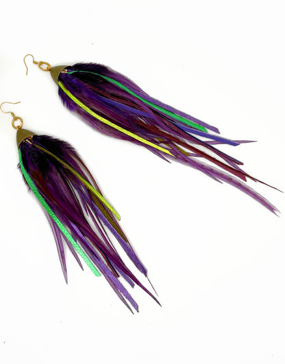 Long purple feather earrings with green leather.