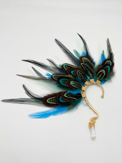 Turquoise blue, mint green and gray pheasant and rooster feather ear cuff. A wire wrapped quartz stone hangs from the bottom of the cuff. 