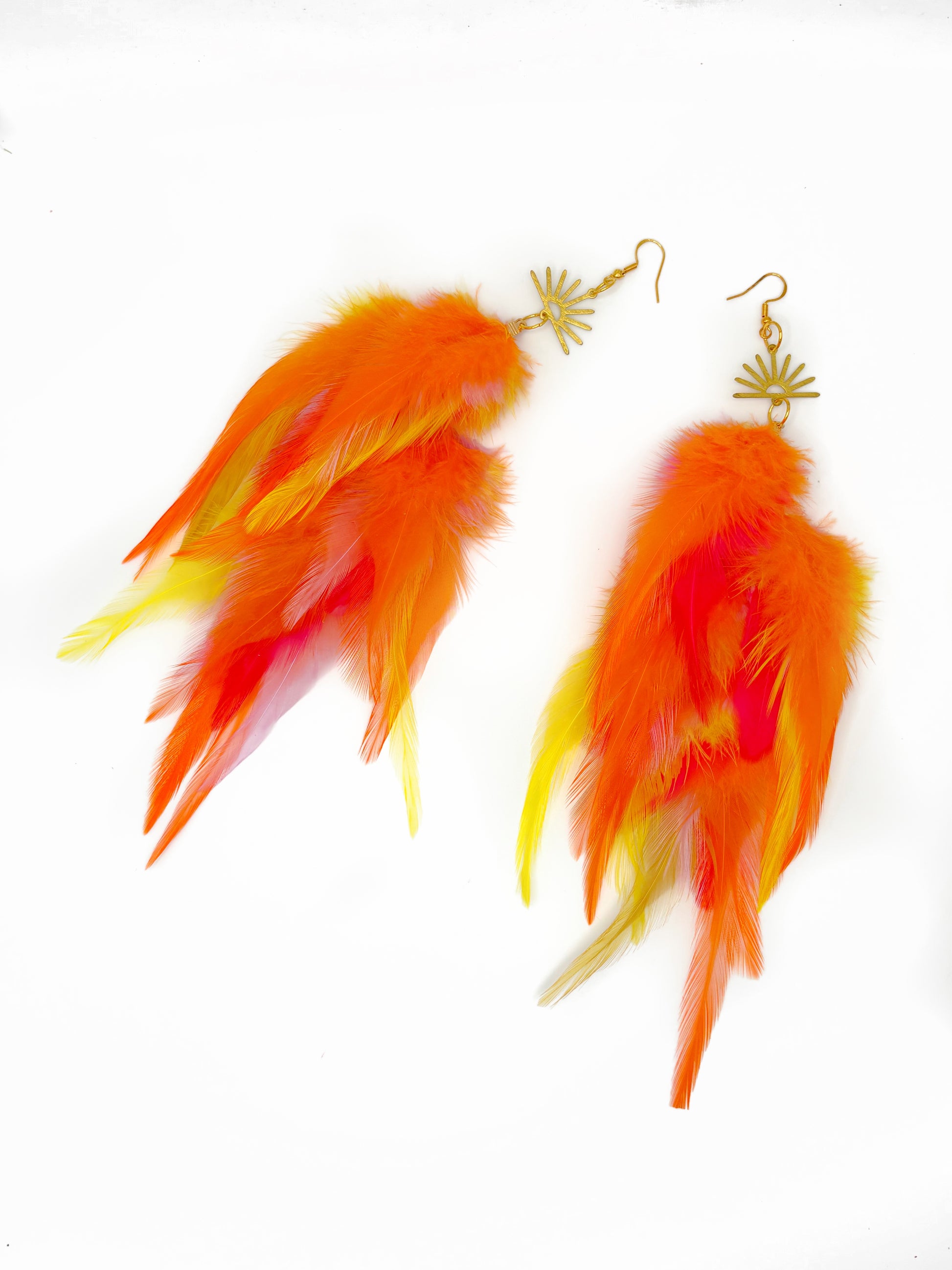 Feather earrings with orange and yellow feathers on a white background