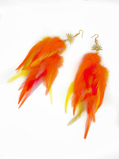 Feather earrings with orange and yellow feathers on a white background