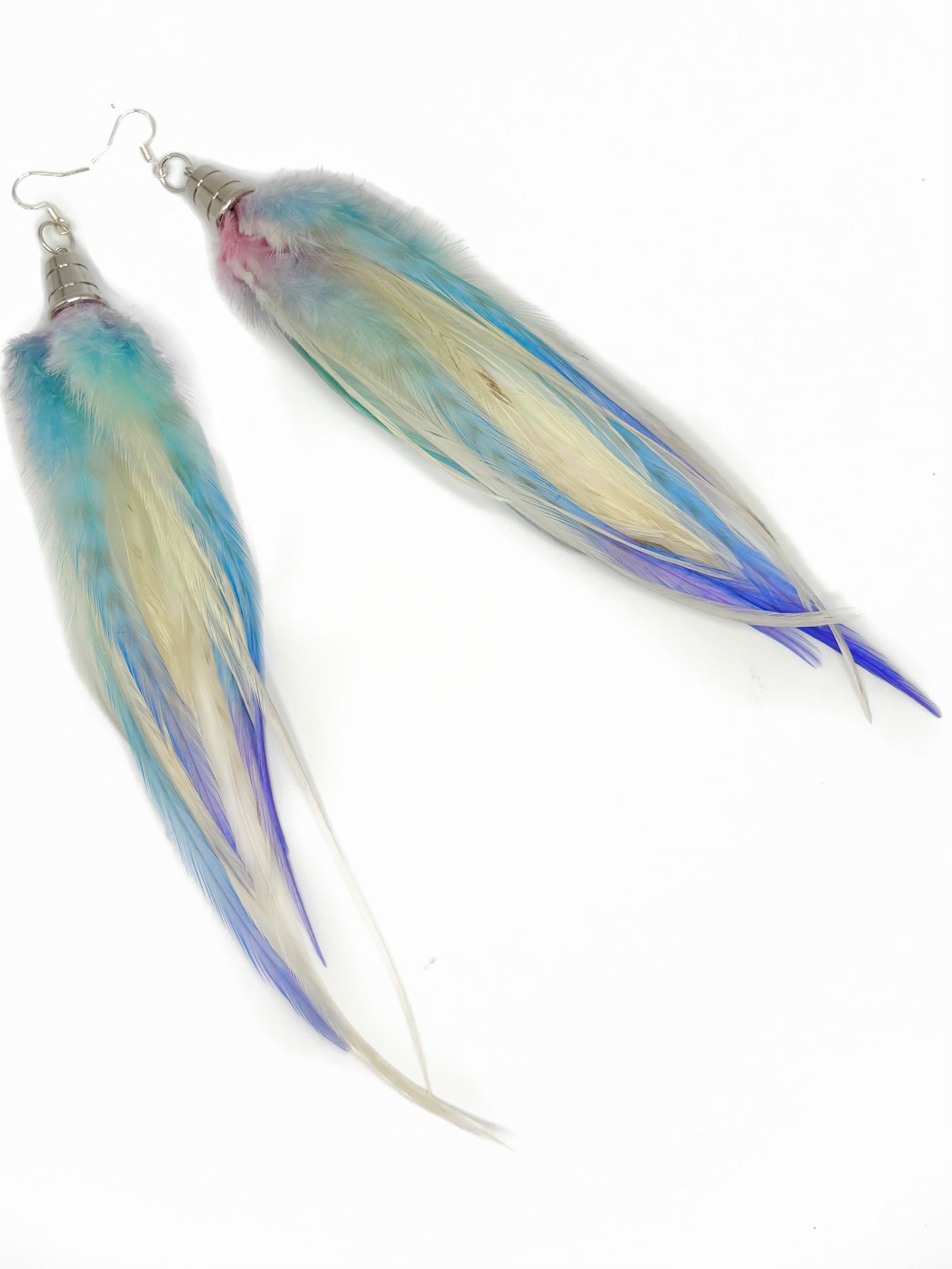 Colorful feather-like earrings on a white background