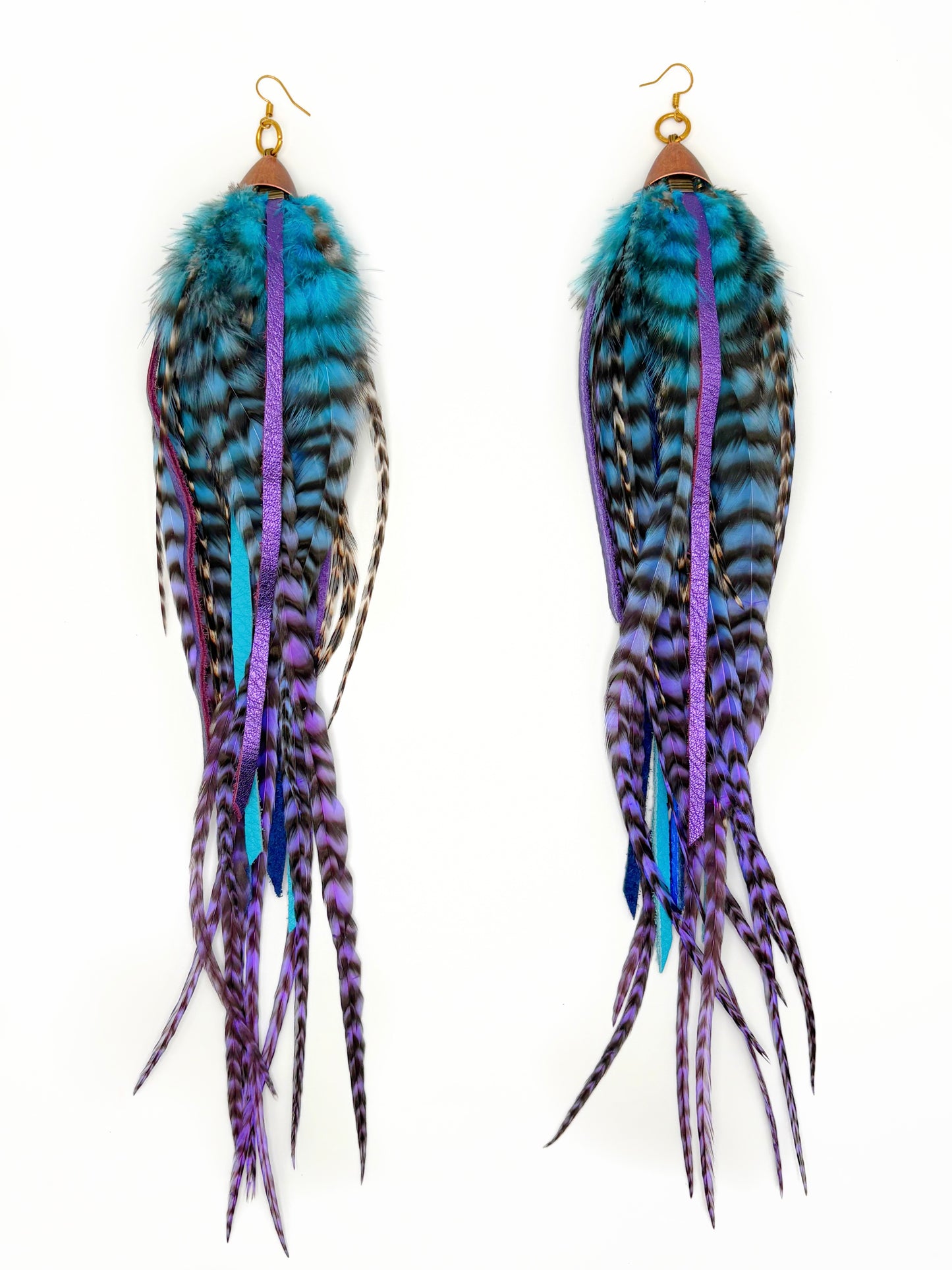 Feather earrings with blue and purple accents on a white background
