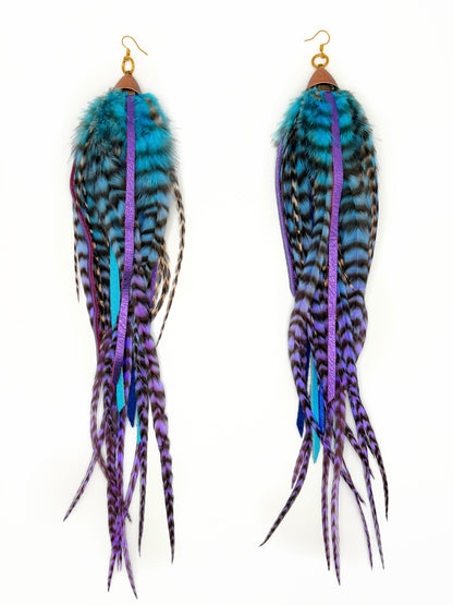 Feather earrings with blue and purple accents on a white background