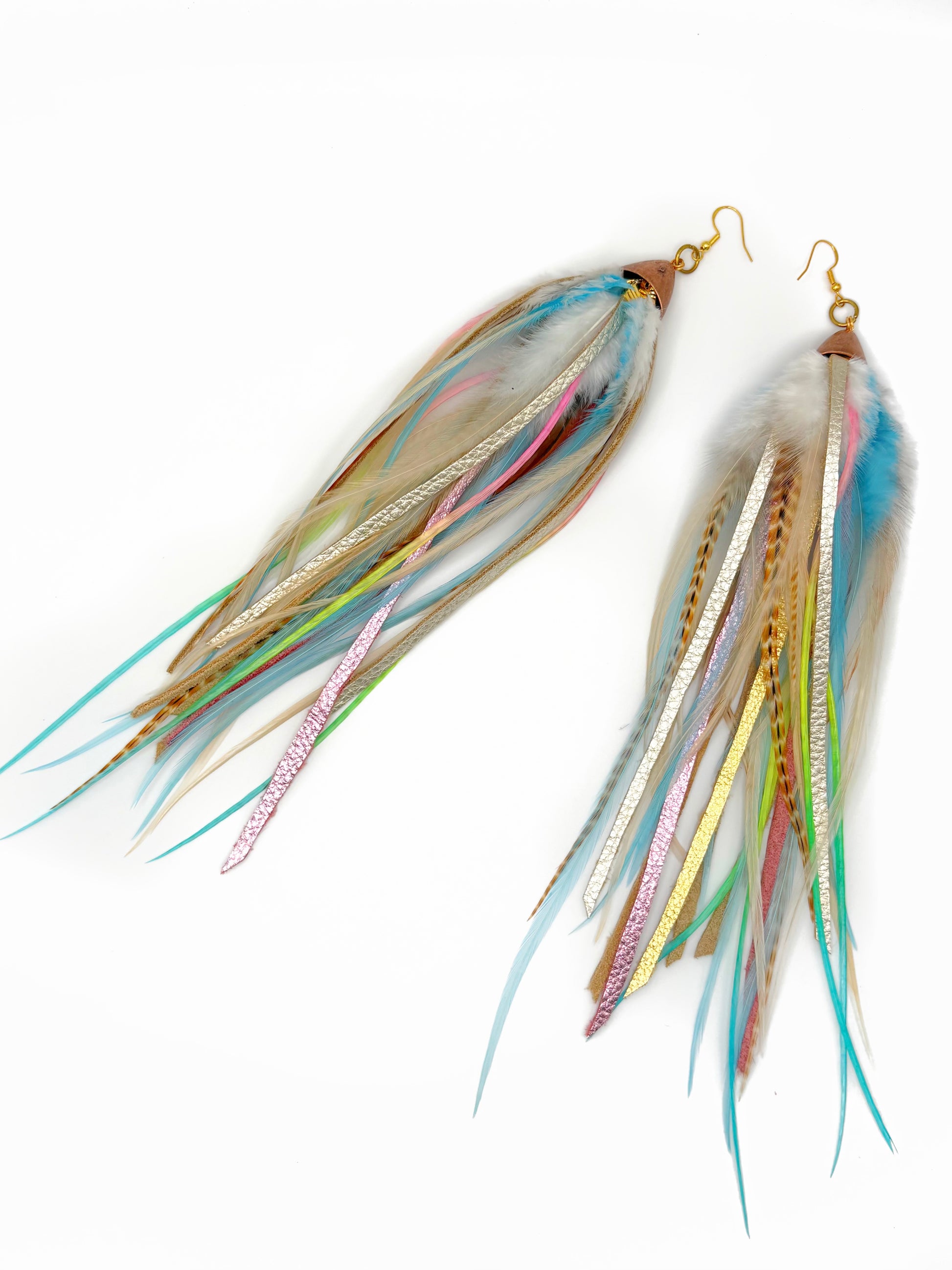 Multicolored feather earrings on a white background