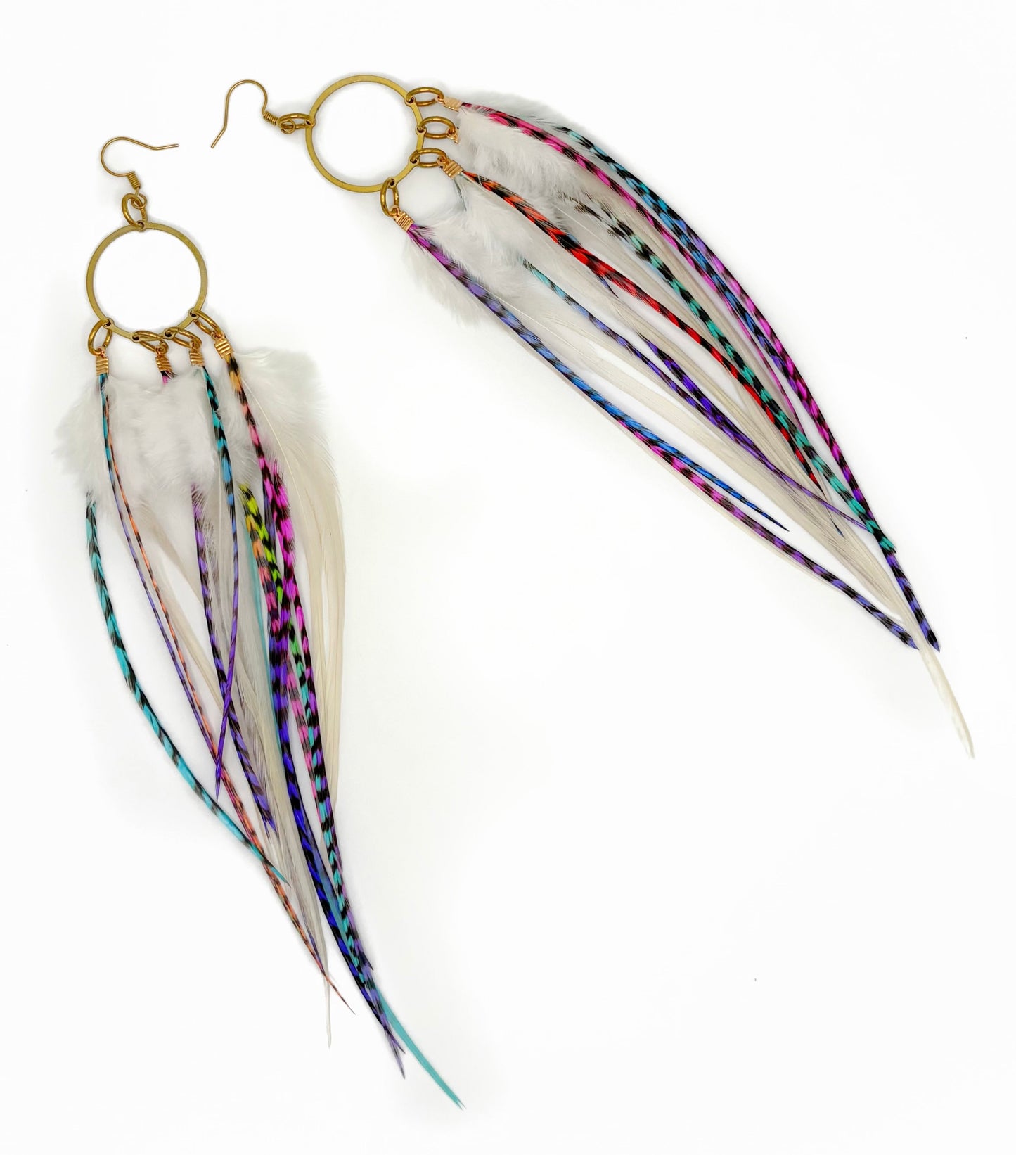 Feather earrings with gold hooks on a white background