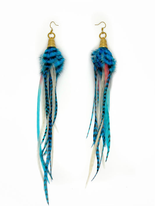 Long feather earrings in blue, white and pink tones. All feathers hang from a gold colored bead cap. 