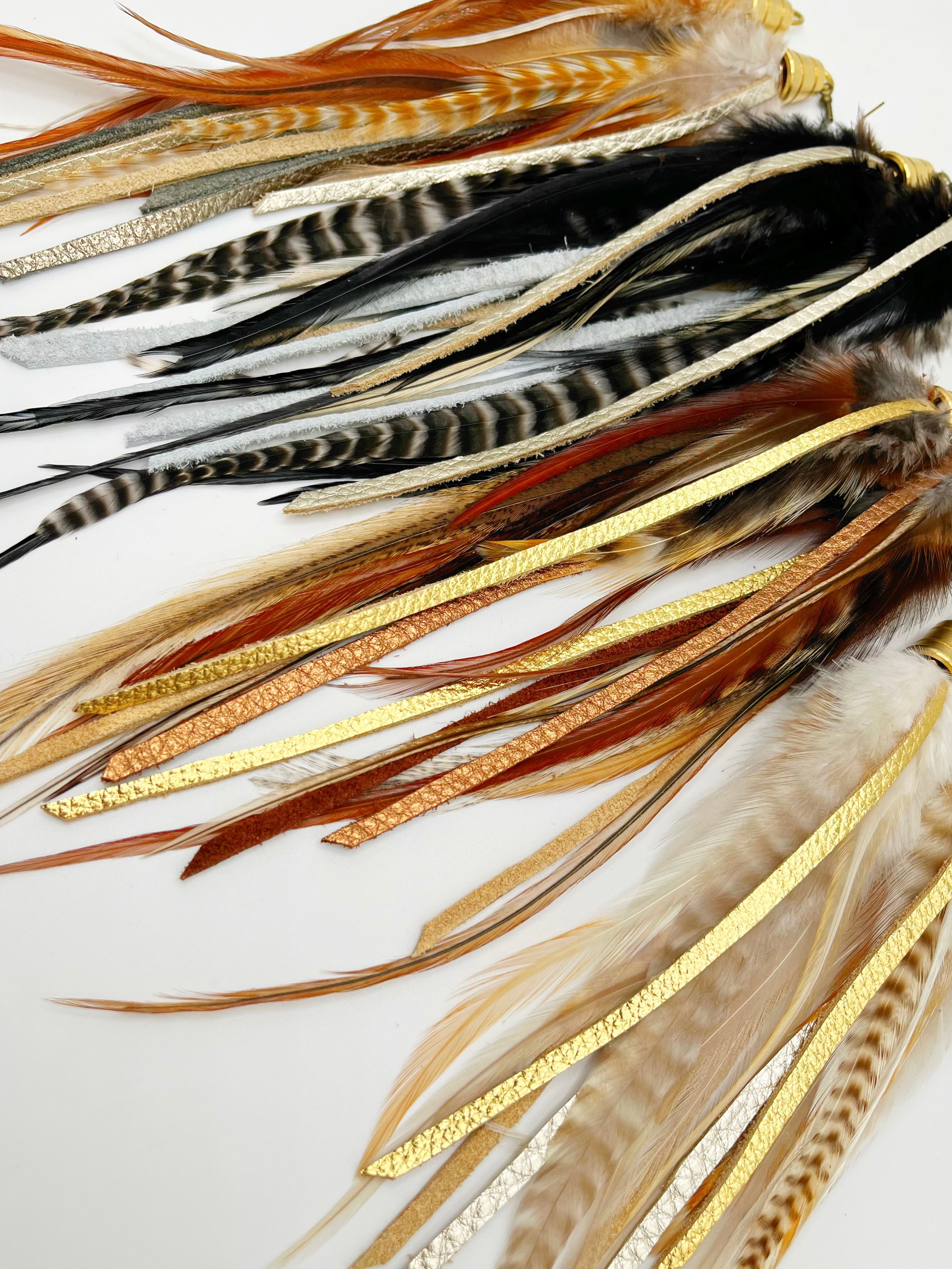 Natural rooster feathers with strips of hand cut gold and bronze leather. 