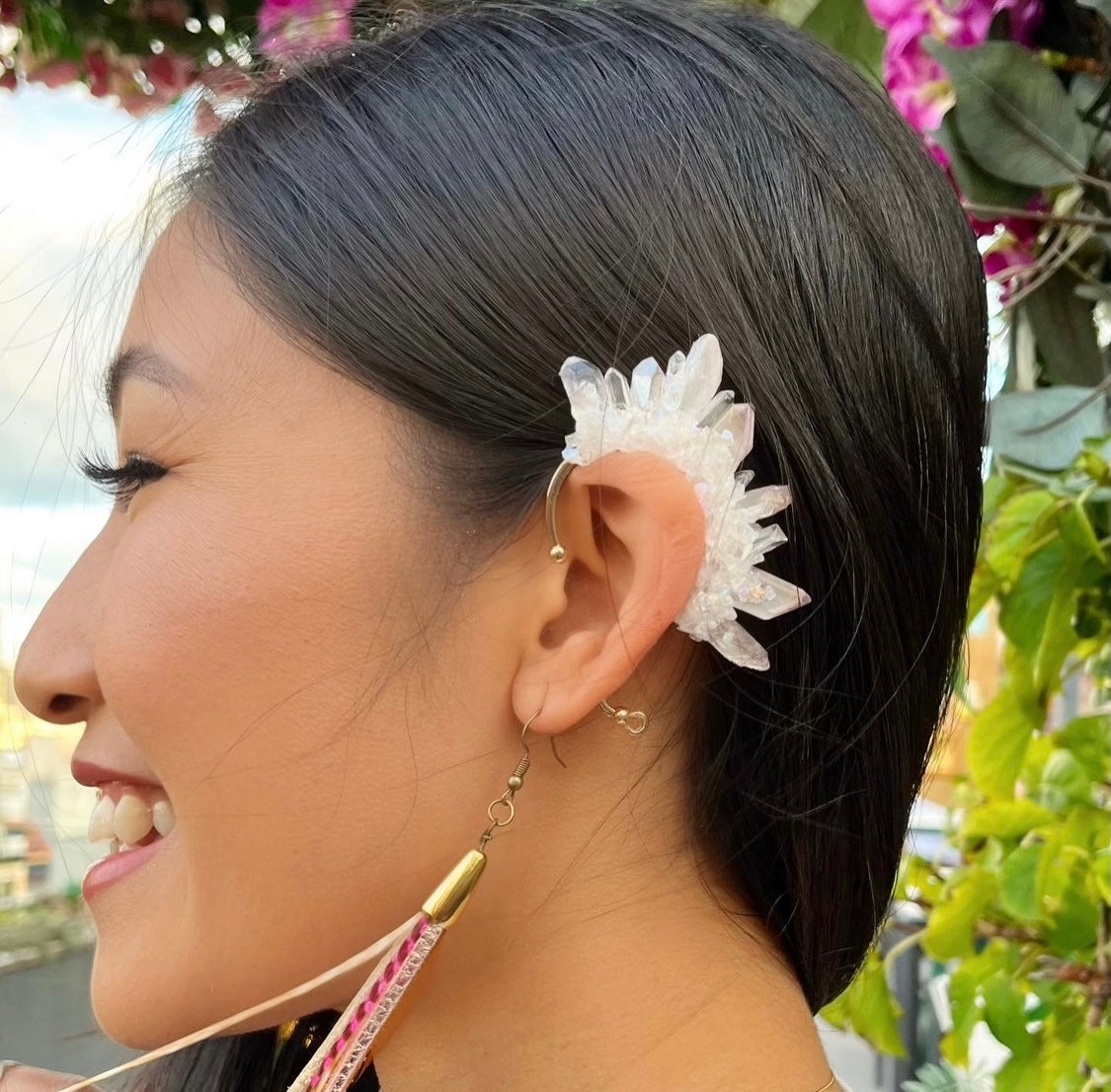 Woman wearing a unique clear quartz crystal ear cuff and matching dangle earring set, showcasing a stylish no-pierce accessory option.